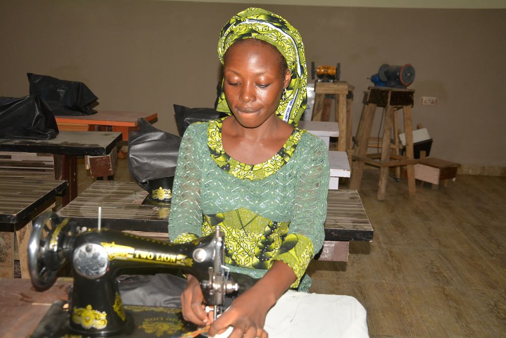Janada Markus works on a clothing project at the skill acquisition department of the Salama Centre in Maiduguri, Nigeria. Janada Markus works on a clothing project at the skill acquisition department of the Salama Centre in Maiduguri, Nigeria.